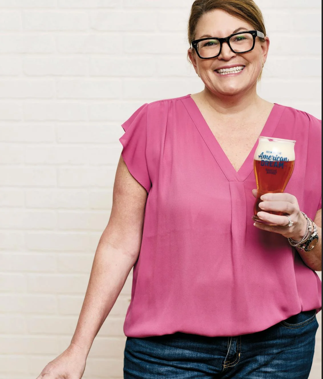 Featured guest Jennifer Glanville Love, author of Our American Dream Cookbook, holding a Samuel Adams beer.
